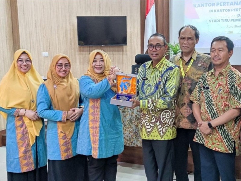 Kepala Kantor Pertanahan Kabupaten Gresik, Kamaruddin, menerima cenderamata dari rombongan Kantah Kabupaten Konawe.