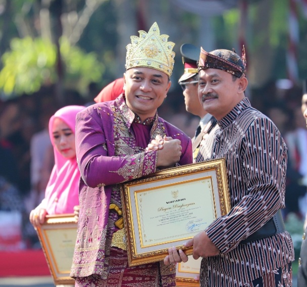 Kepala Seksi Survei dan Pemetaan, Marjuki (kanan), menerima penghargaan dari Wali Kota Surabaya.