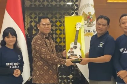 Wakil Ketua DPR RI, Adies Kadir, menerima cenderamata dari perwakilan musisi jalanan.