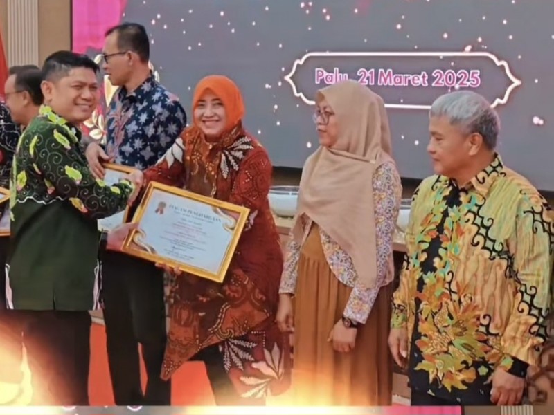 Kepala Kantor Wilayah Badan Pertanahan Nasional Sulawesi Tengah, Muh Tansri memberikan penghargaan kepada salah satu pegawai.